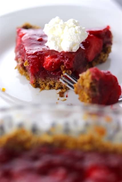 Fresh Strawberry Pie with An Oatmeal Cookie Crust bitten on a white plate