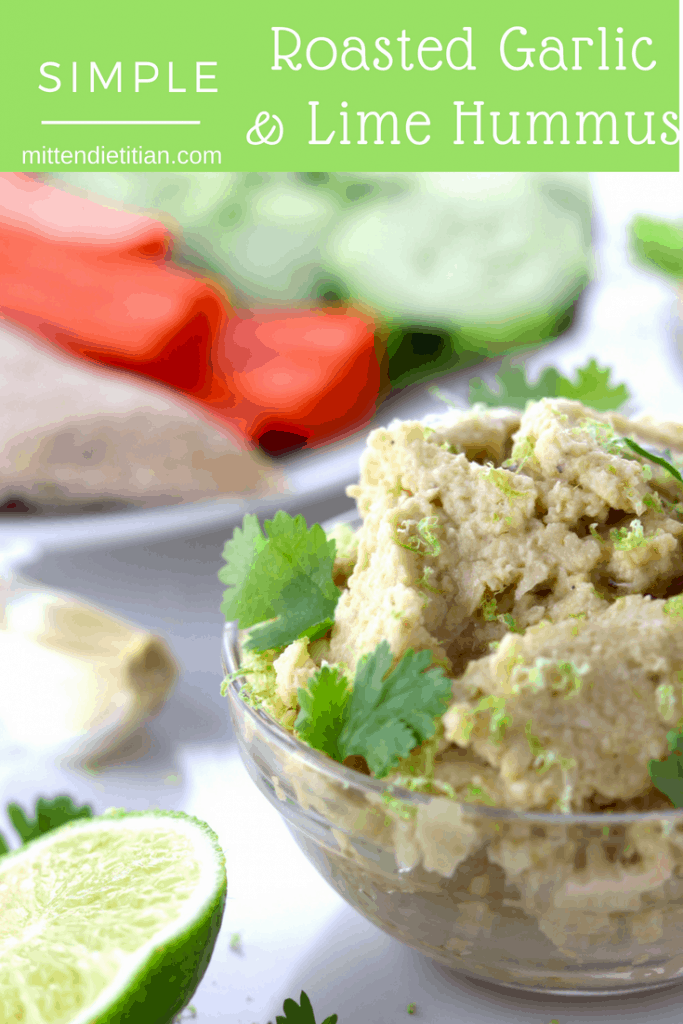 Simple roasted garlic and lime hummus in a dish with veggies