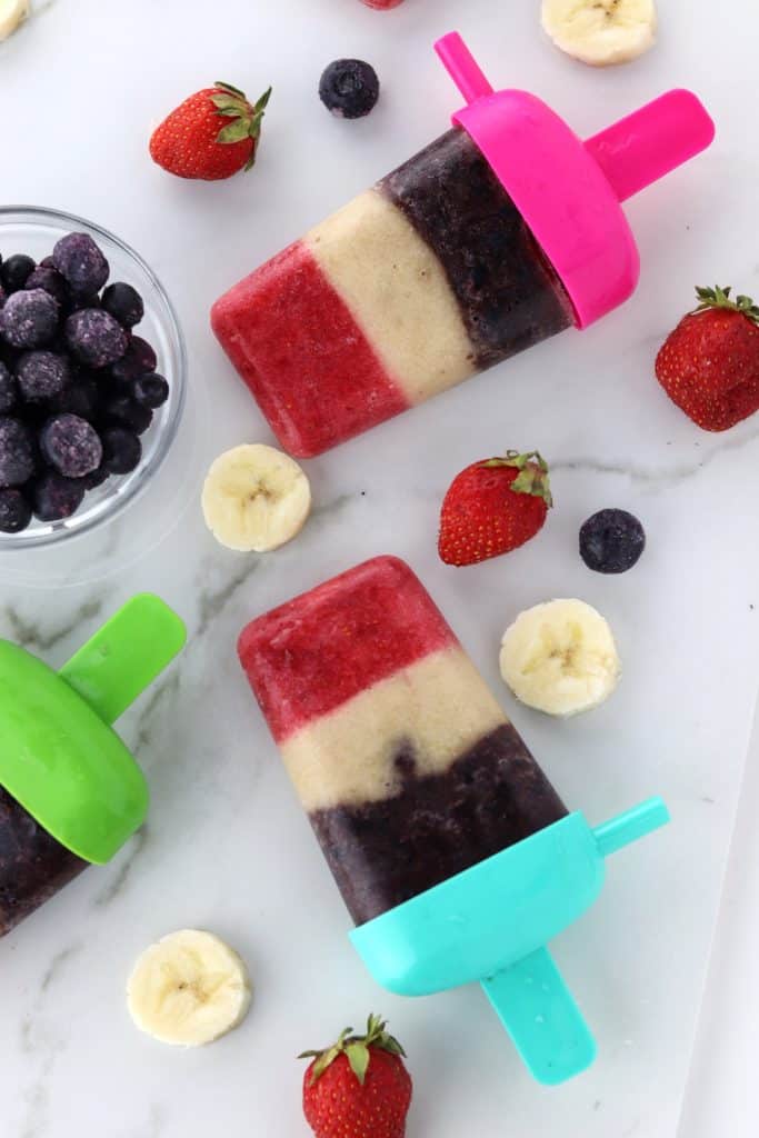 red white and blue fruit pops sitting on a counter top