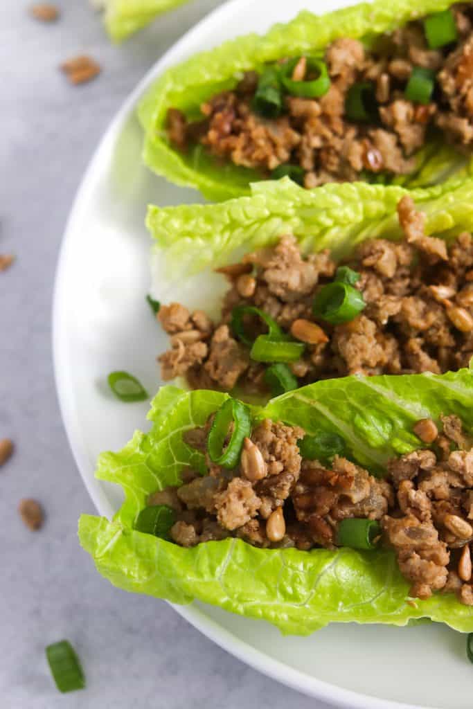 These easy, healthy & freezer friendly chicken lettuce wraps will become a weeknight staple! The secret ingredient (SunButter!) gives them AMAZING flavor you won't be able to get enough of! #easyrecipes #dinnerrecipes #freezerfriendly #weeknightmeal