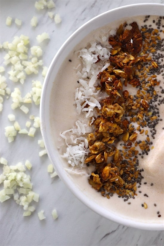 Cauliflower Smoothie Bowl On counter with granola, coconut and chia seeds