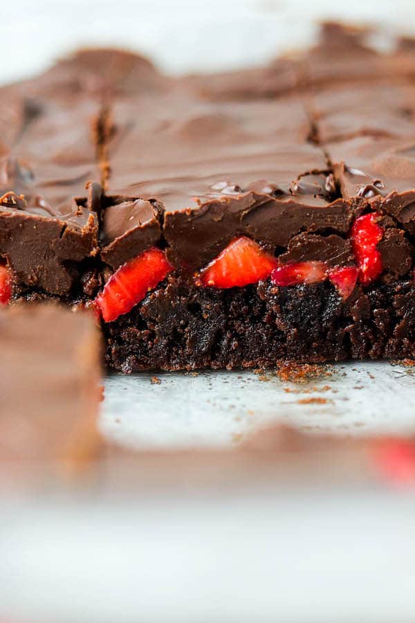 Side angle of layered chocolate covered strawberry brownies.