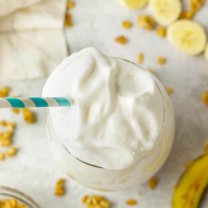 top of a banana protein shake with granola around the sides.