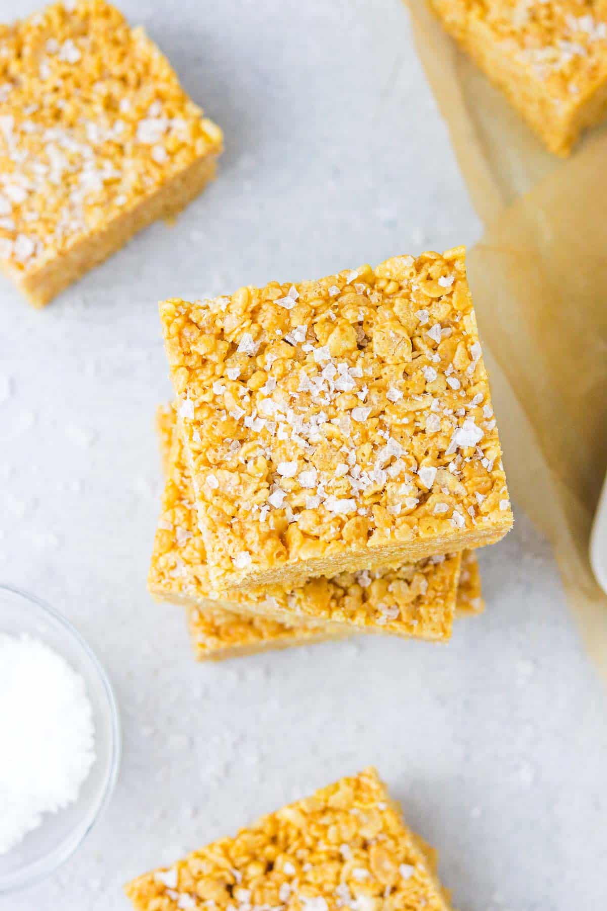 Top of a stack of cereal bars, sprinkled with flaky sea salt.