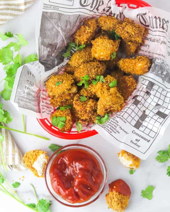 extra crispy spicy chicken nuggets in a basket with ketchup