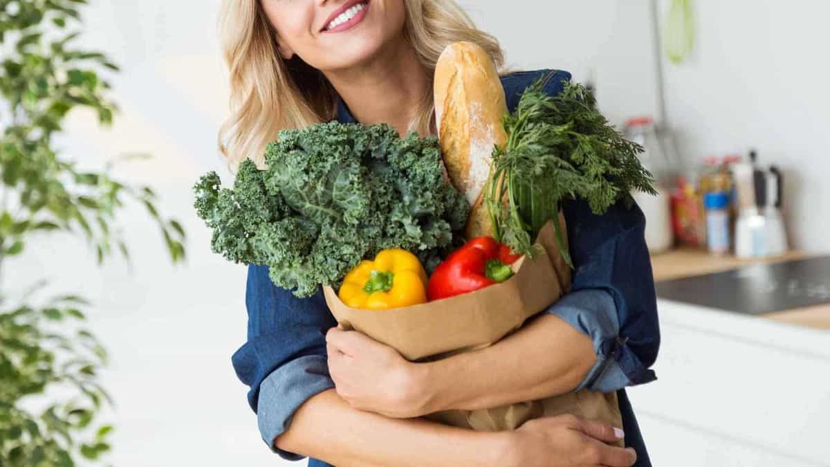 woman holding a bag of produce