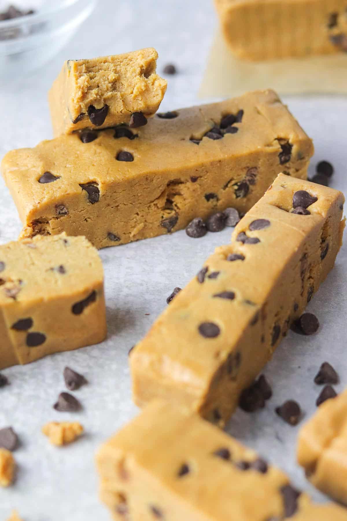 Chocolate chip cookie dough protein bars with a bite out.