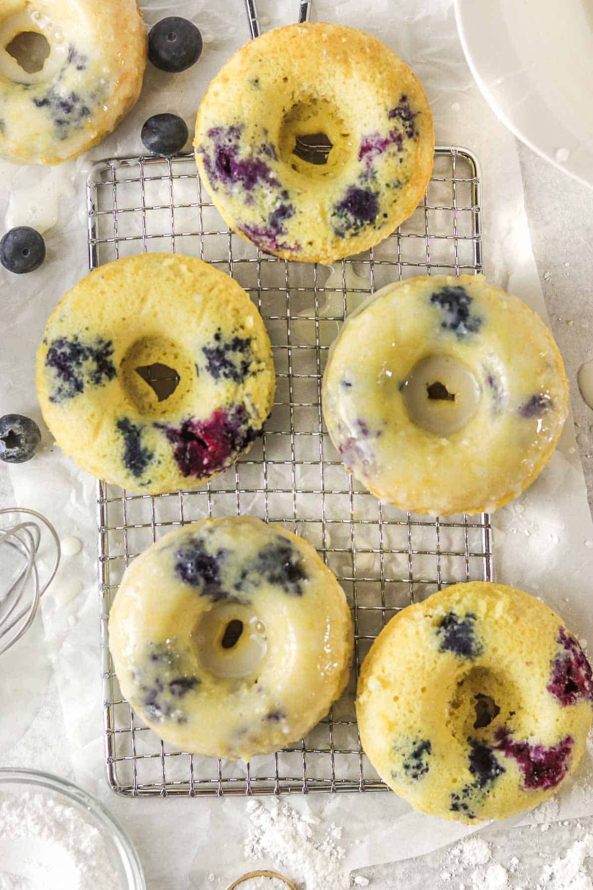 blueberry cake donuts on a cooling rack.