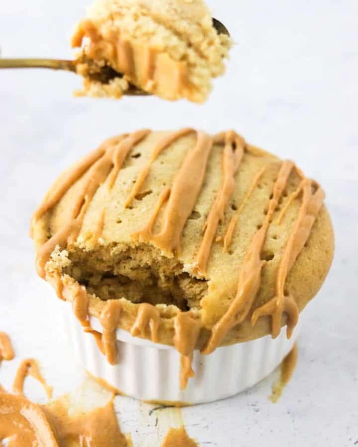 eating peanut butter protein mug cake with spoon