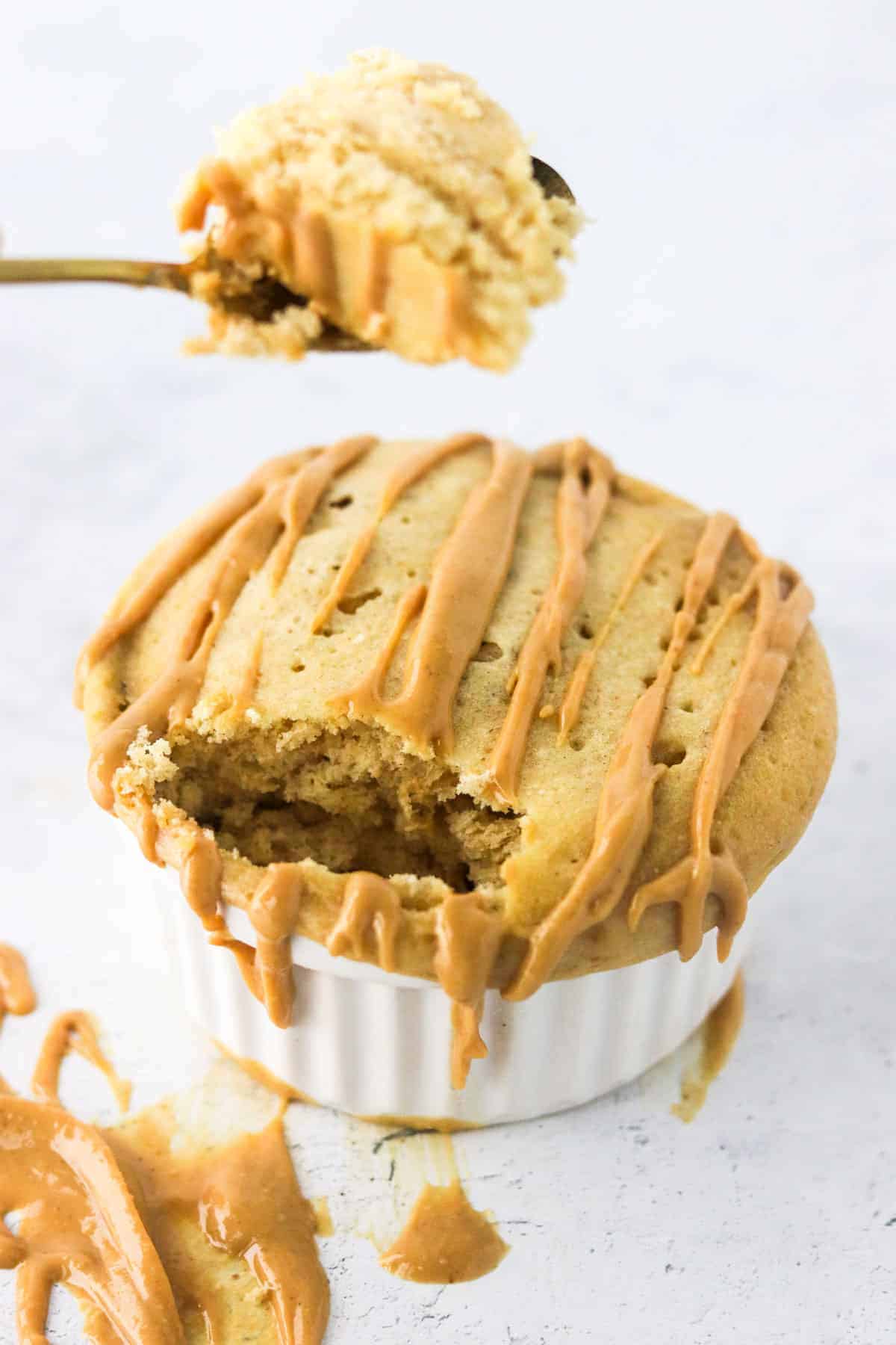 eating peanut butter protein mug cake with spoon