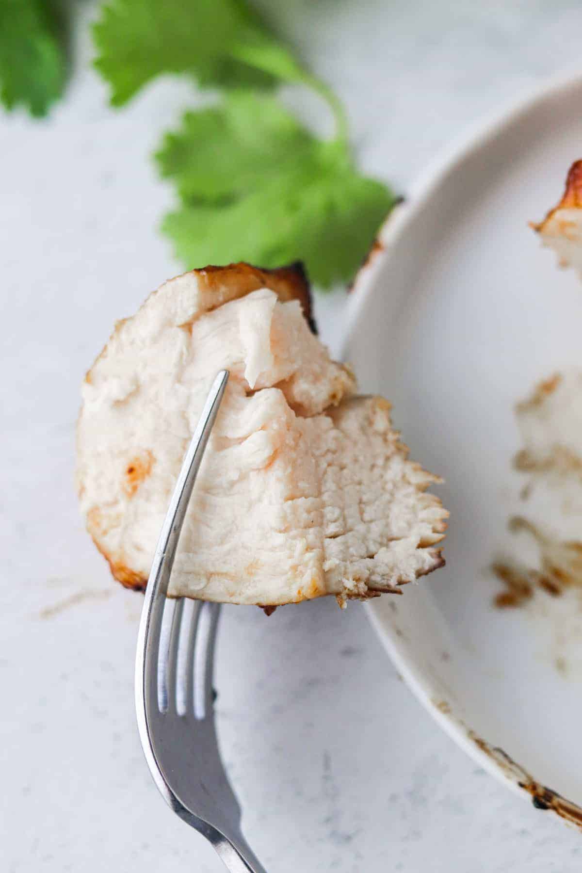 piece of air fryer bbq chicken on a fork