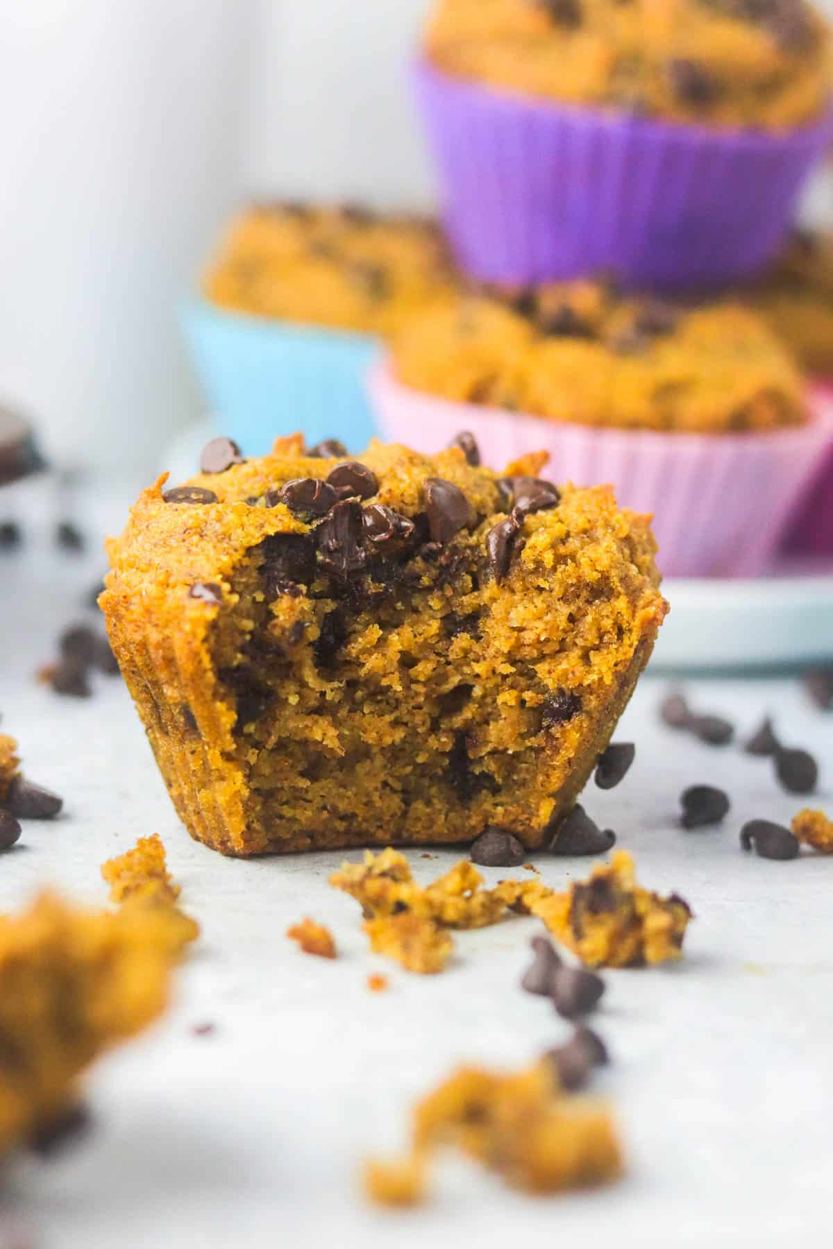 Close up shot of a half eaten gluten free pumpkin muffin.