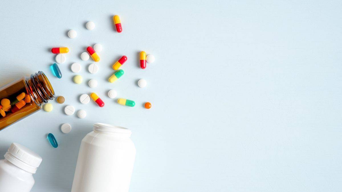 Pills coming out of a pill bottle.