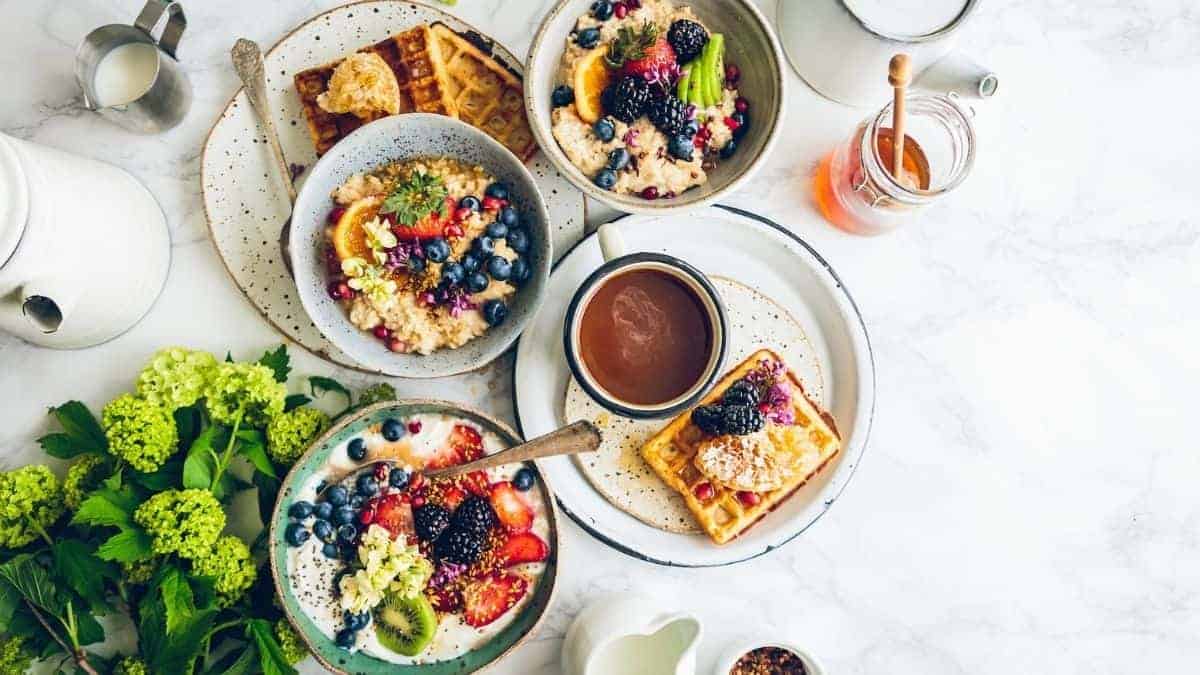 an assortment of breakfast foods spread out on a table.