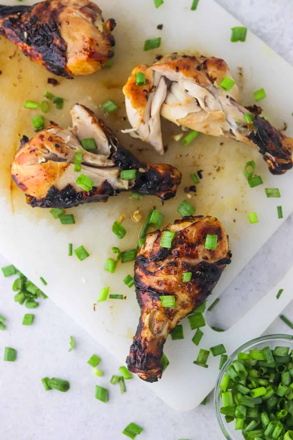 honey soy air fryer drumsticks on cutting board.