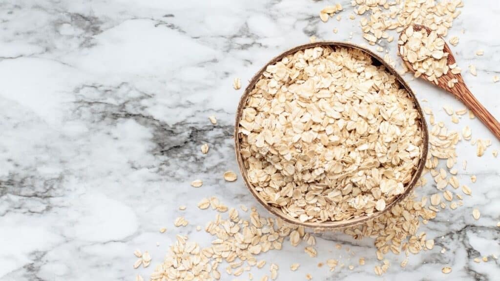 A marble background with a bowl of quick oats.