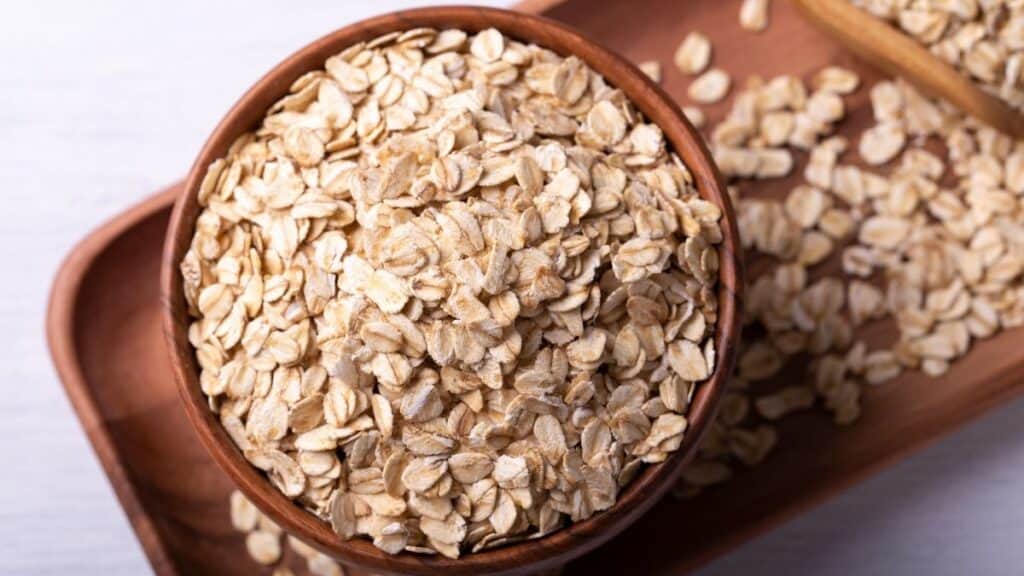 A wooden bowl of rolled oats.