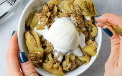 Perfect apple crisp in a bowl being eaten.