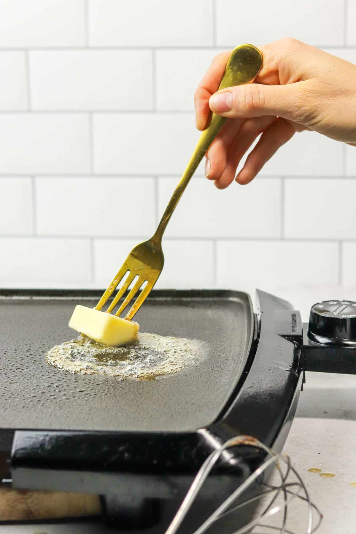 melting butter on a hot griddle.