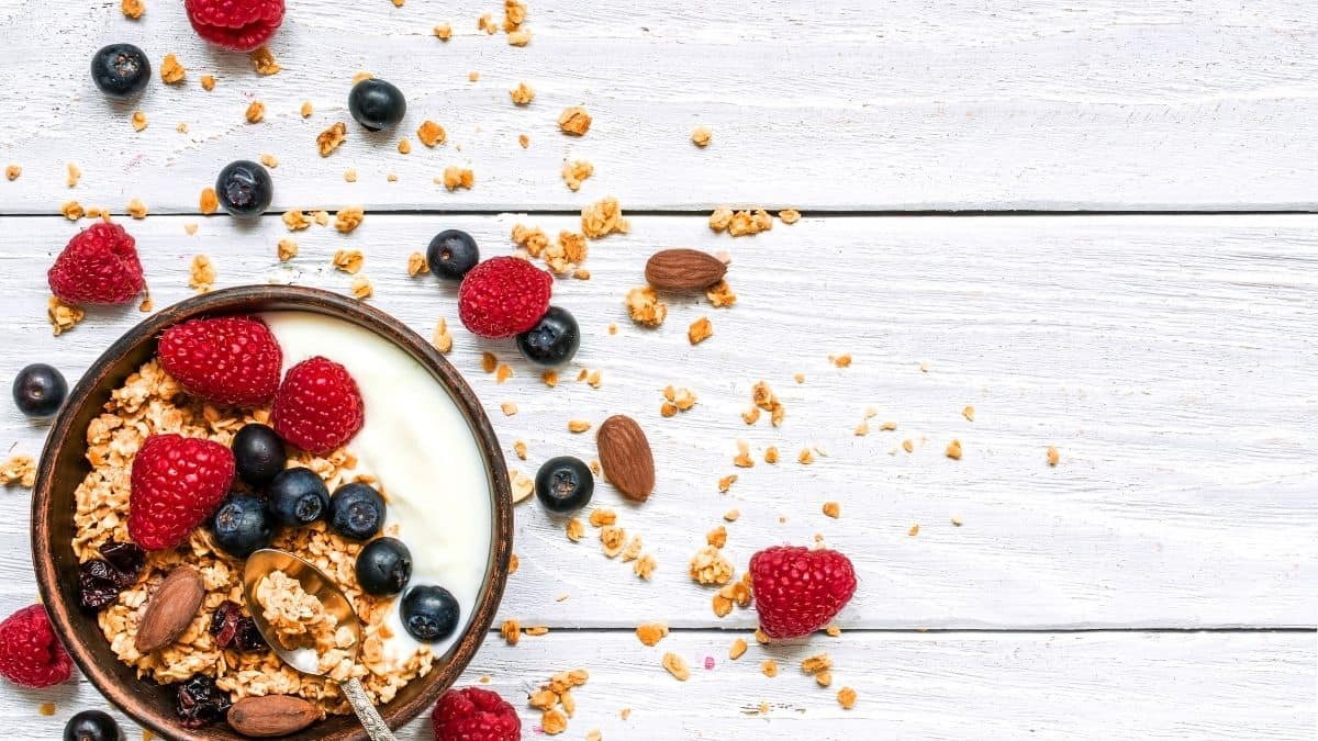 a bowl of yogurt, granola and berries.