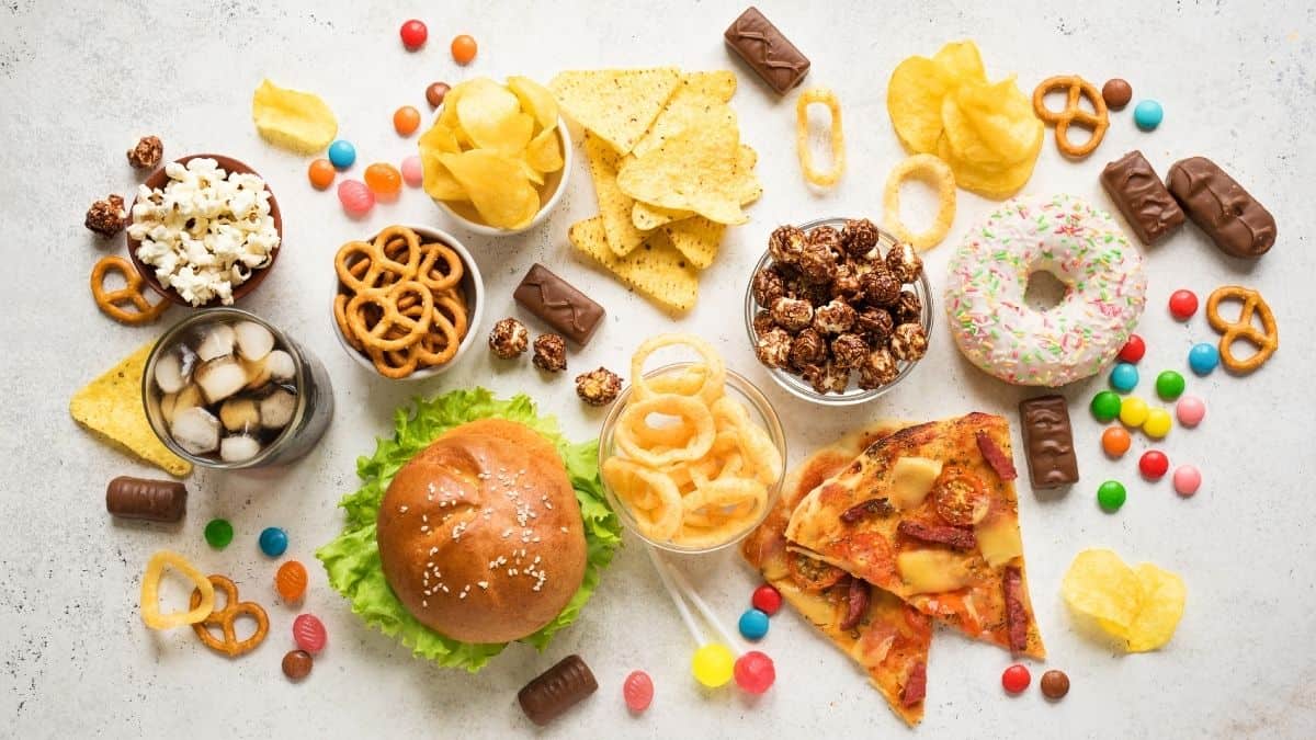 A variety of \"unhealthy\" or \"junk\" food on a table.