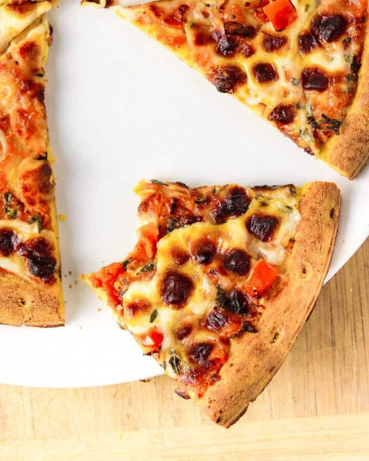 close up half eaten air fryer frozen pizza slice.
