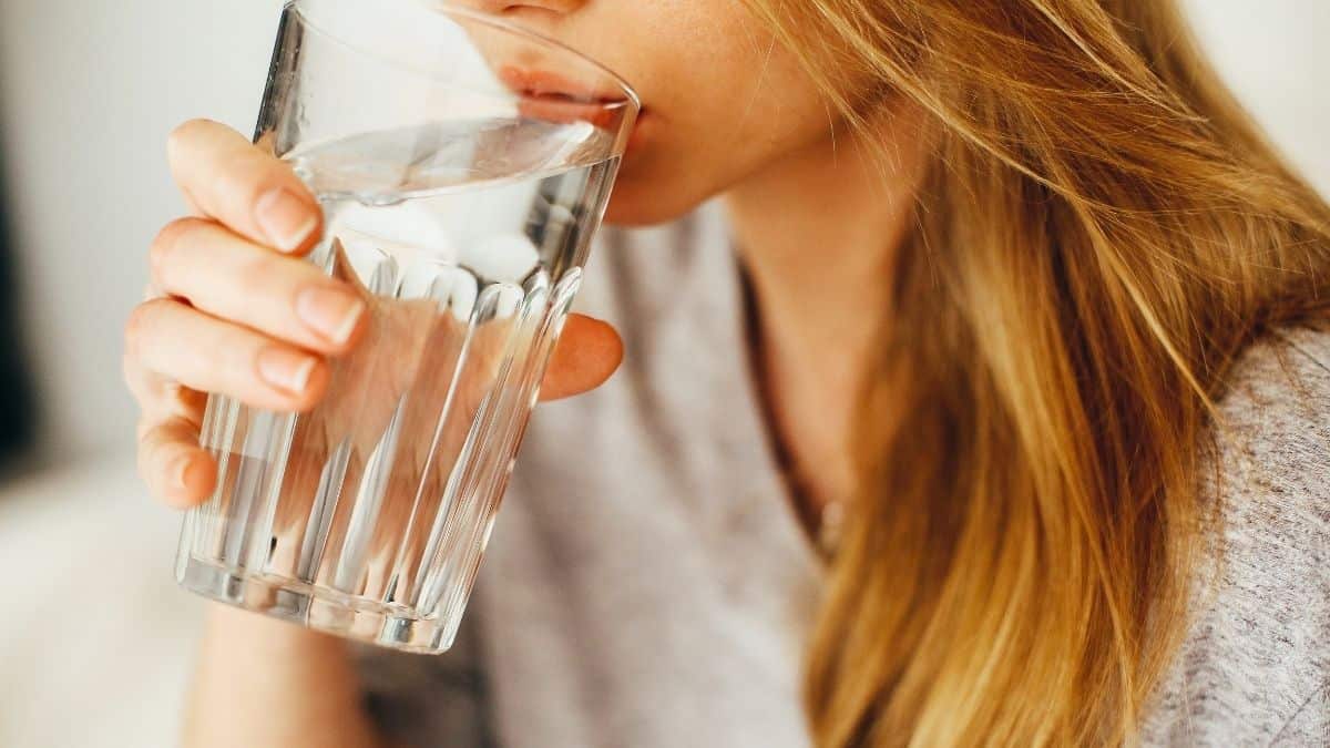 woman drinking a glass of water.