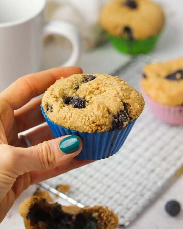 Holding A Gluten Free Blueberry Muffin.