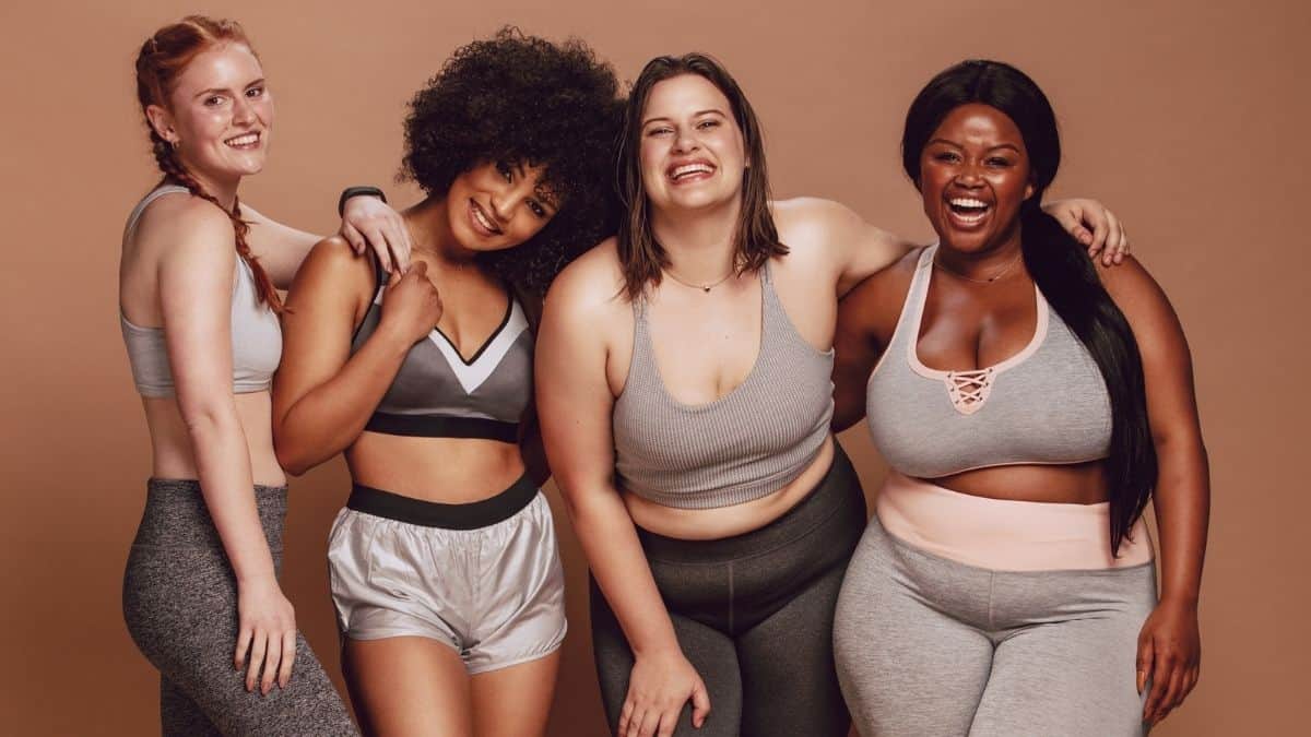 Women of varying body sizes looking happy in sports bras.