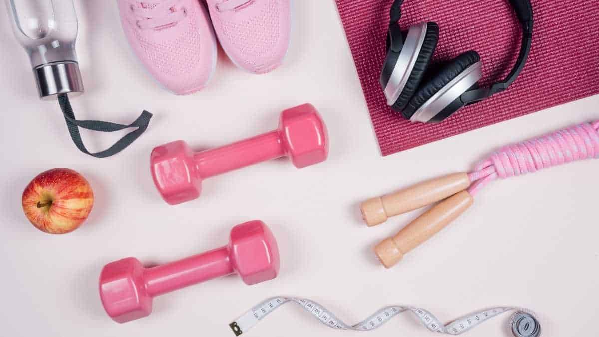 pink health & fitness gear spread out on a white surface.
