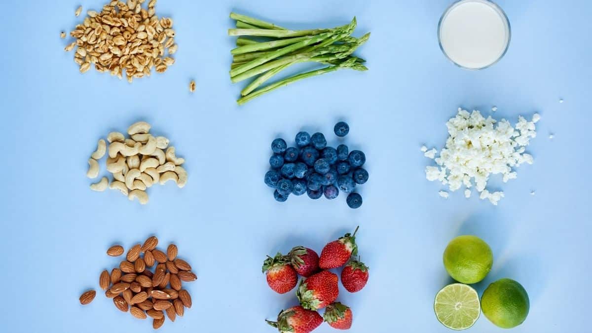 variety of foods separated out spread out on a blue background.