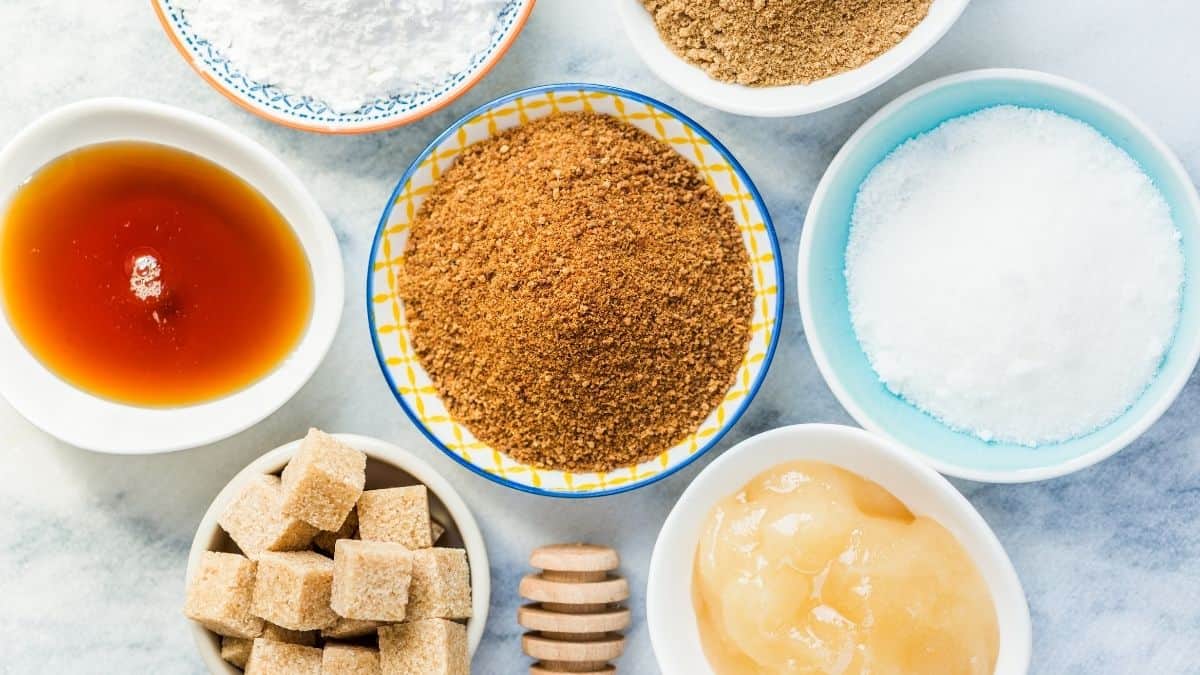 Different types of refined and unrefined sugar in bowls,