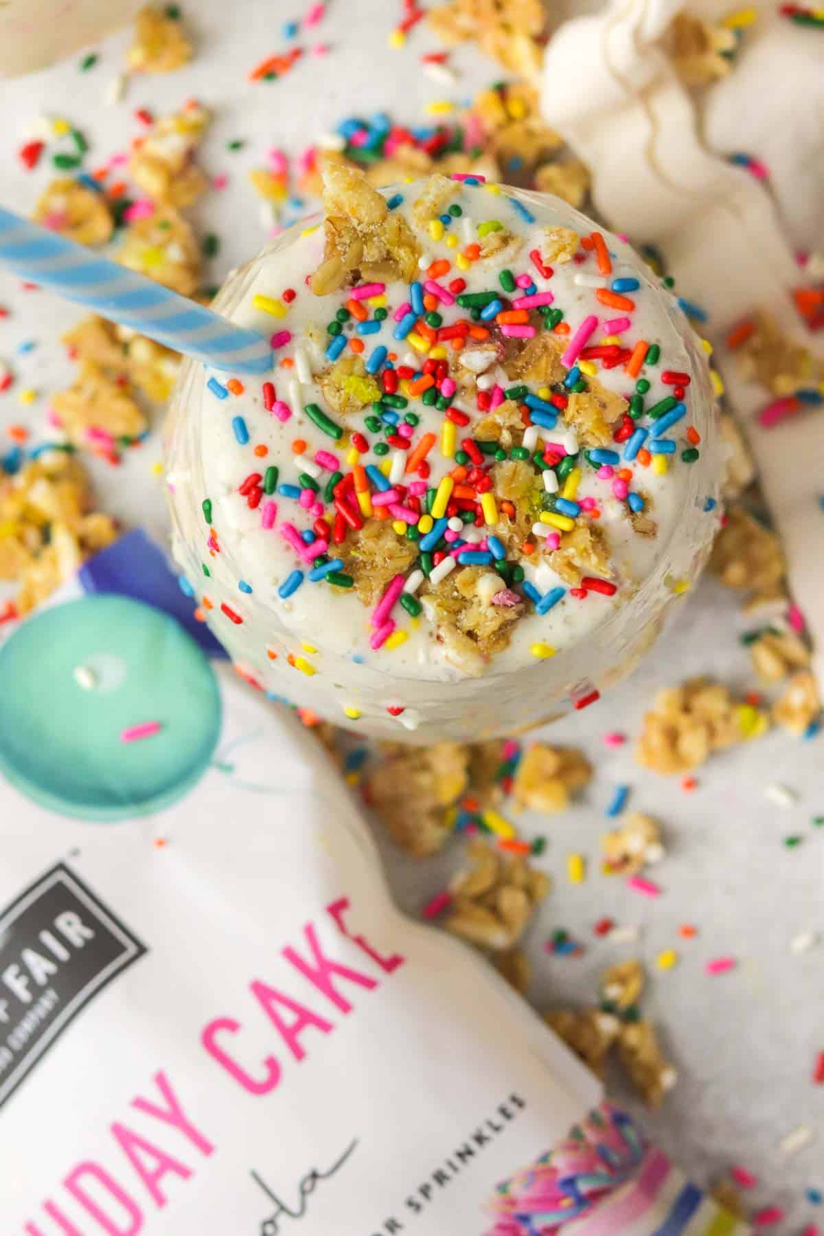 Top of a birthday cake protein shake with sprinkles and birthday cake granola.