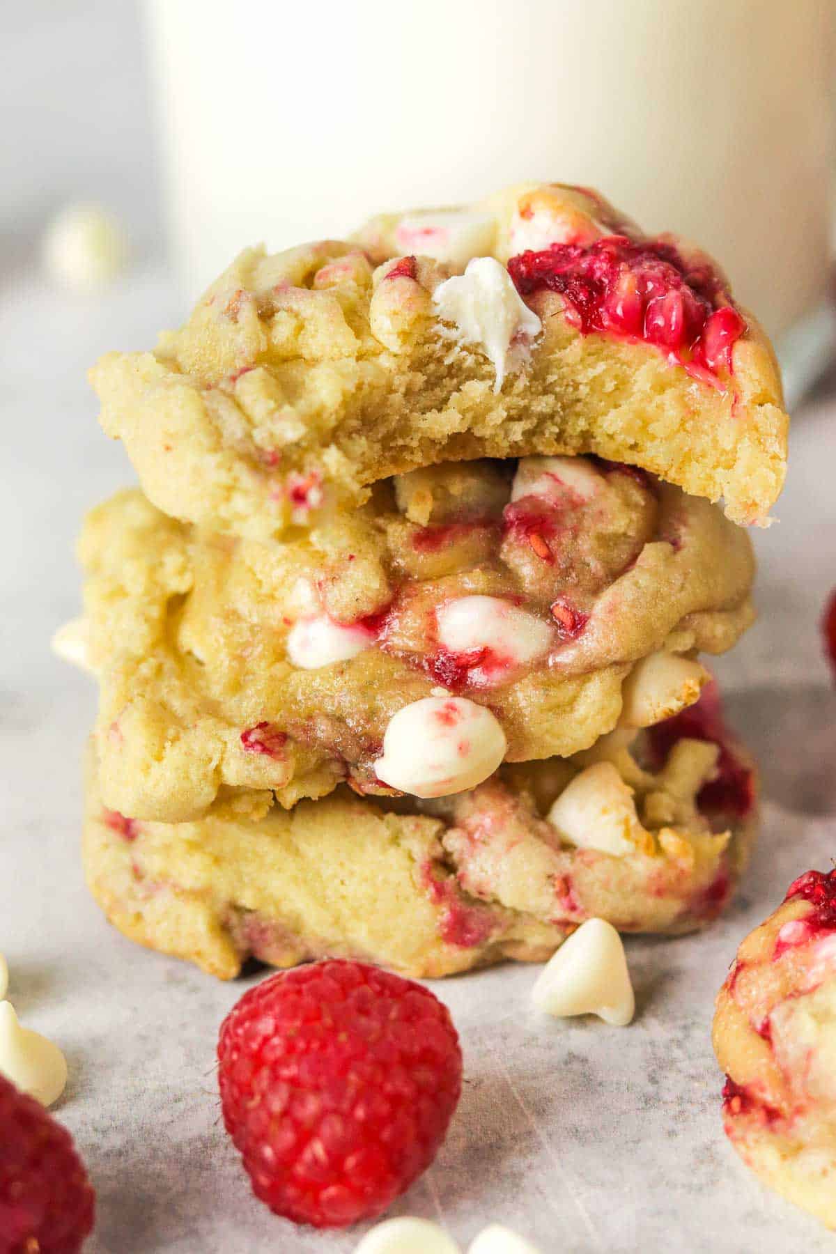 stacked white chocolate raspberry cookies with a bite out