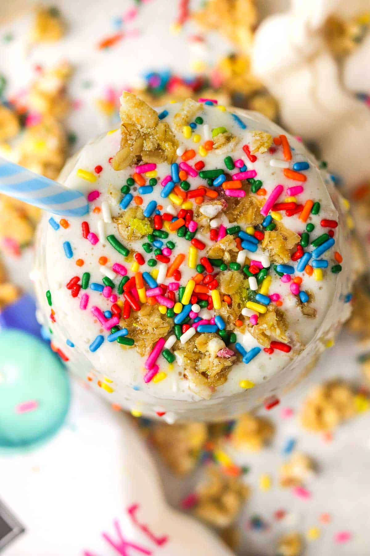 up close top of a birthday cake protein shake with extra sprinkles.