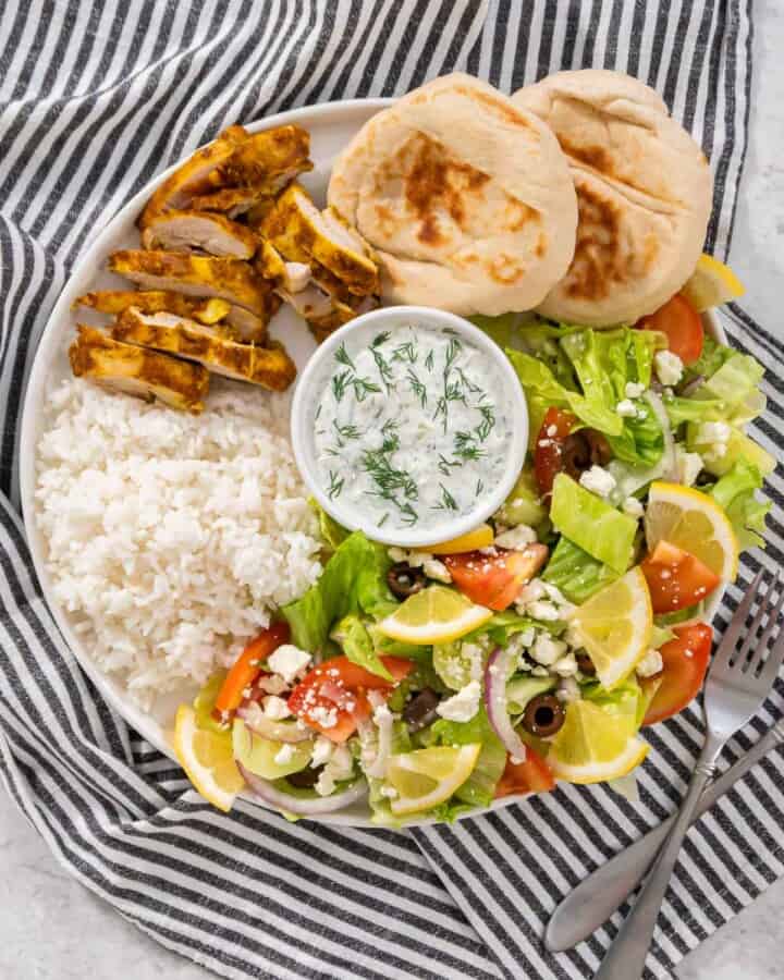 Up close chicken shawarma plate with a striped napkin.