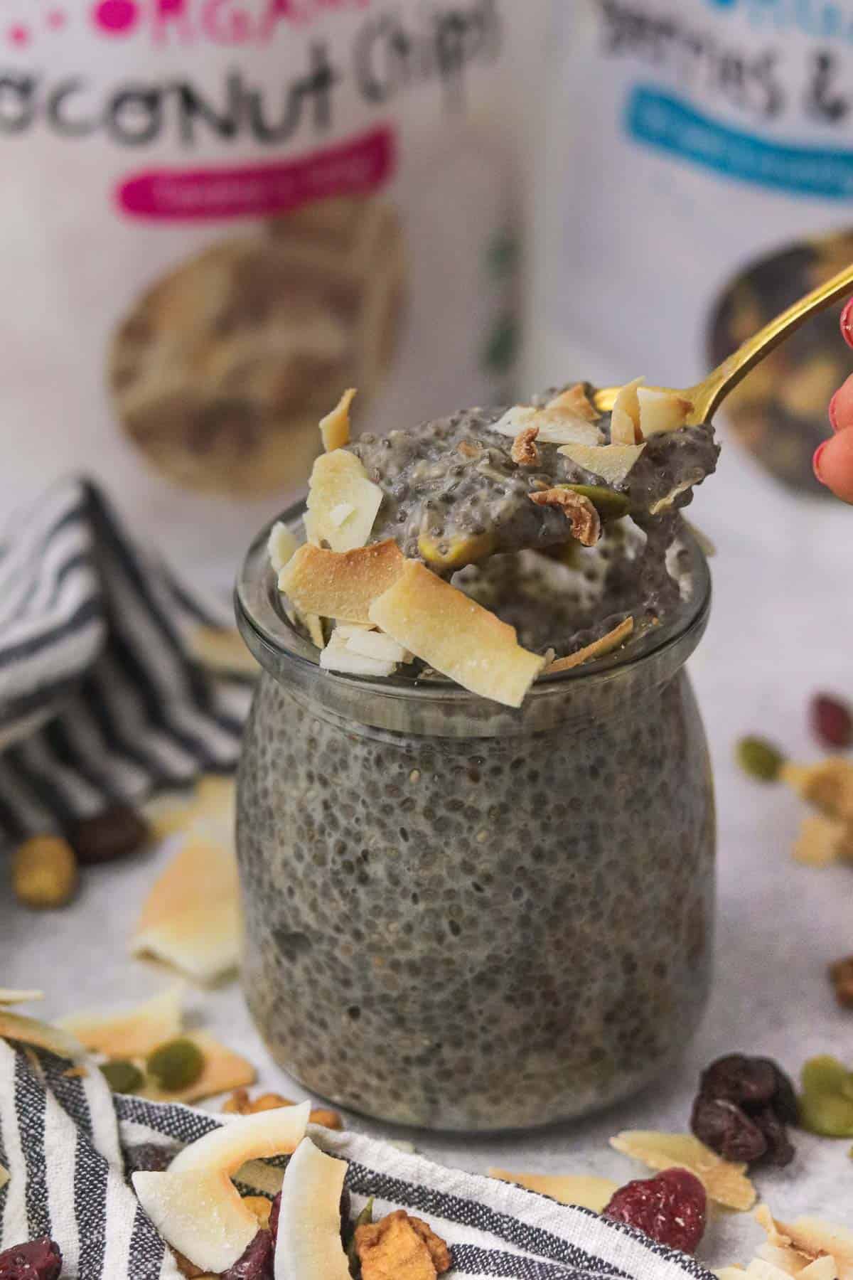 scooping protein chia pudding with toppings on it.