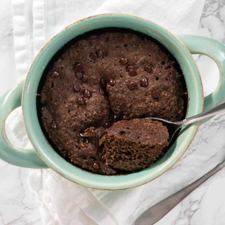 5 Minute Chocolate Baked Oats In A Mint Green Bowl.