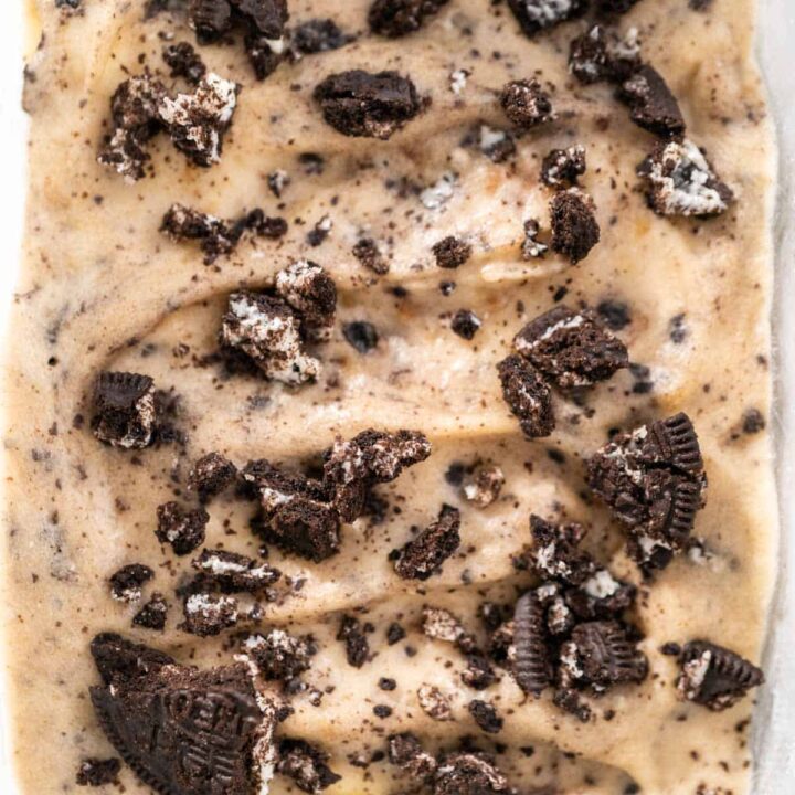 A close up of Cookies and Cream Nice Cream in a glass container, focusing on the texture and crumbled chocolate wafers on top.