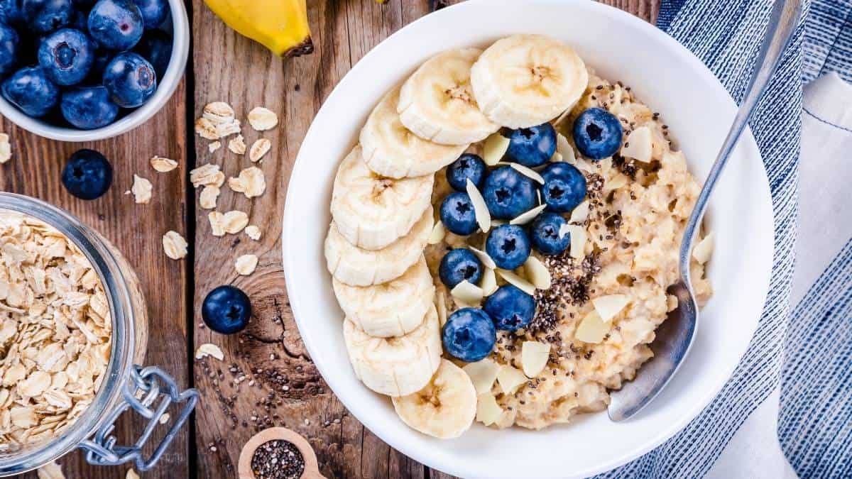 a bowl of oatmeal topped with blueberries and banana.