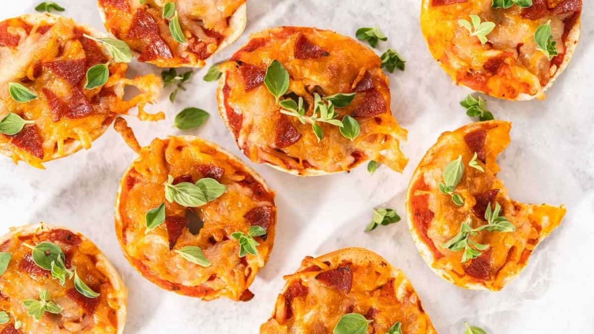 Air Fryer Pizza Bagels on a white and grey background.