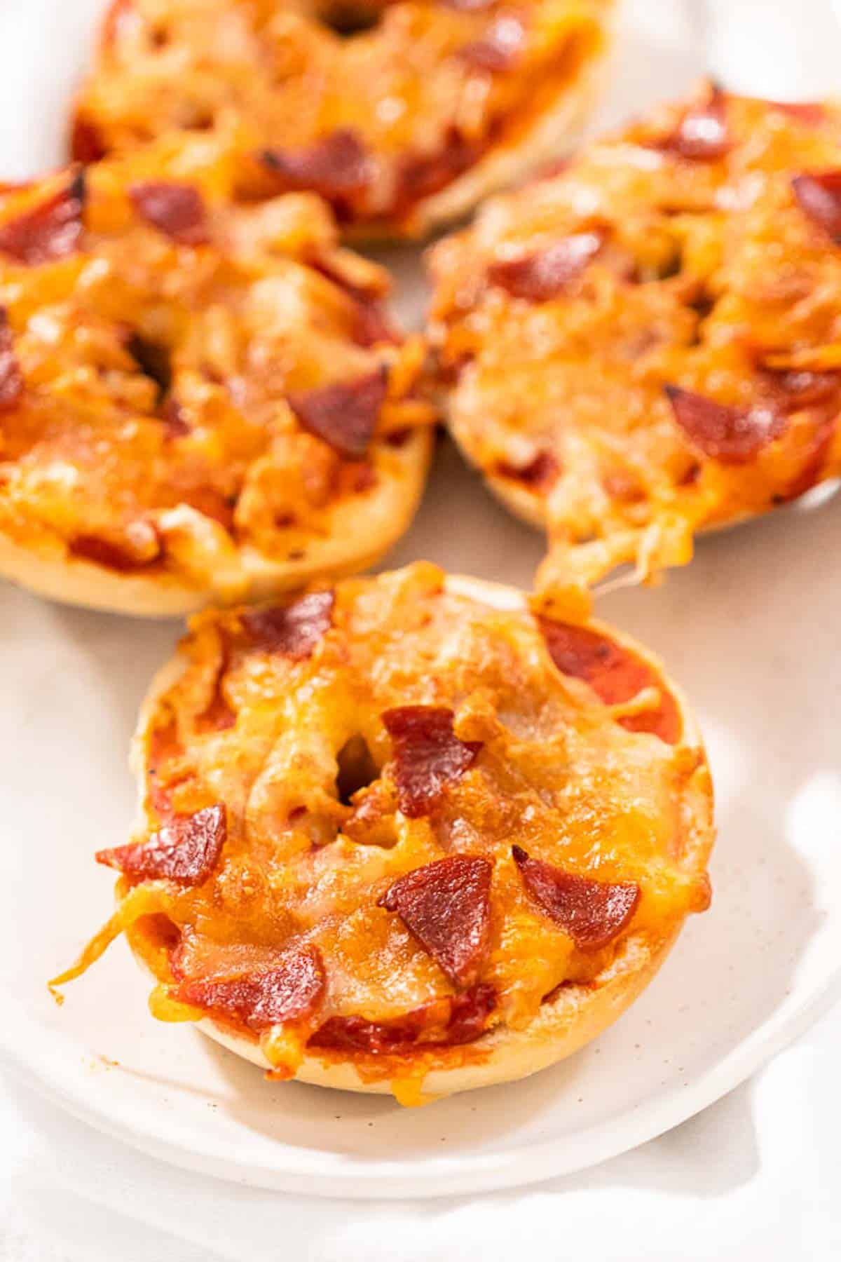 Air fryer pizza bagels on a white plate.