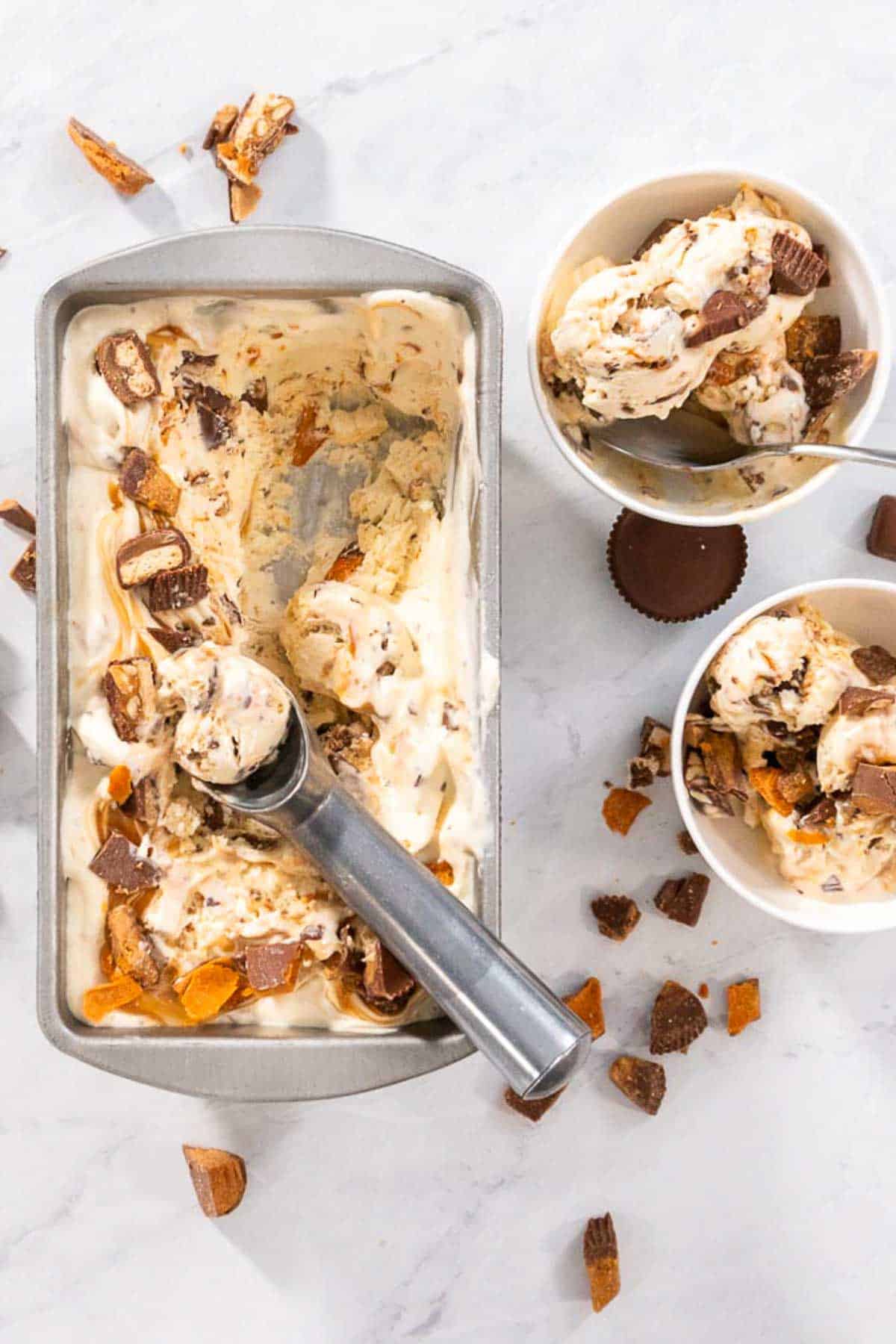 An overhead shot of No Churn Chocolate Bar Ice Cream with two bowls filled with two servings to the side.