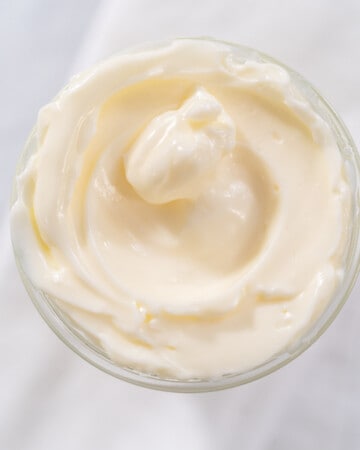 Close up of whole egg mayo in glass bowl.
