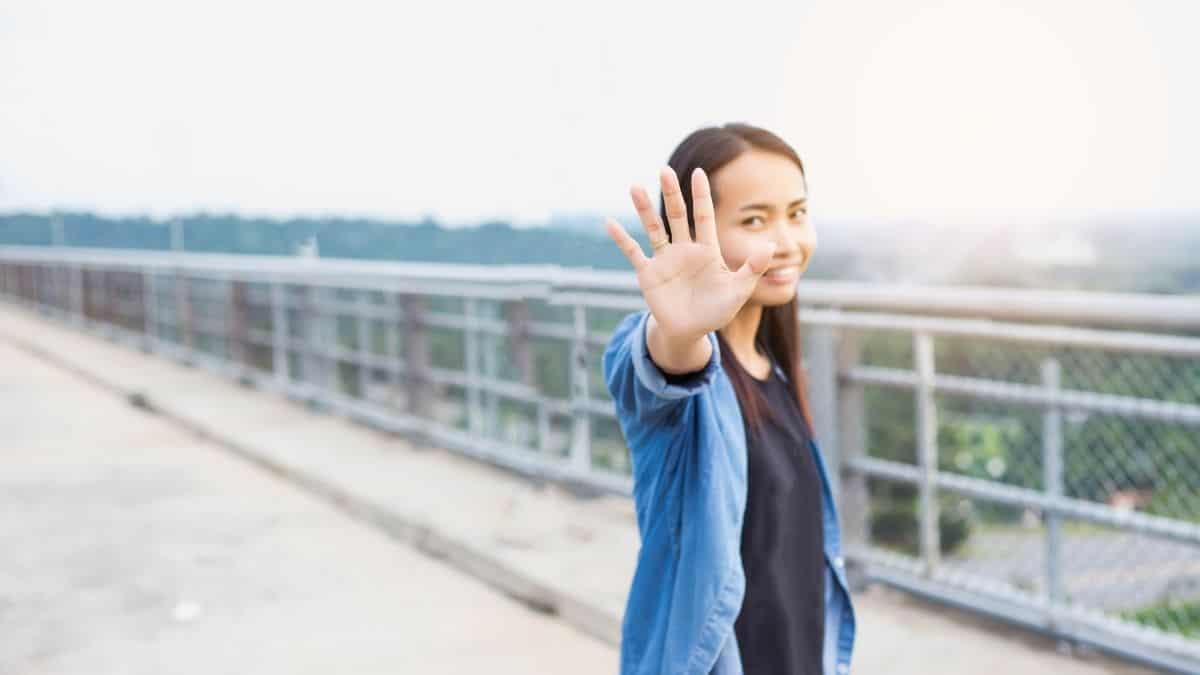 a woman holding her hand out in front of her to signal stop to dieting.