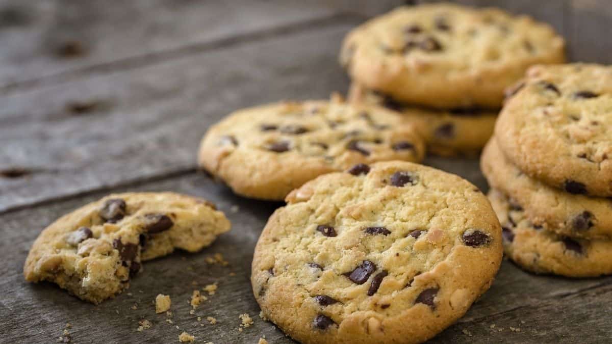 A pile of cookies, one partially eaten, an example of something someone can't stop eating.