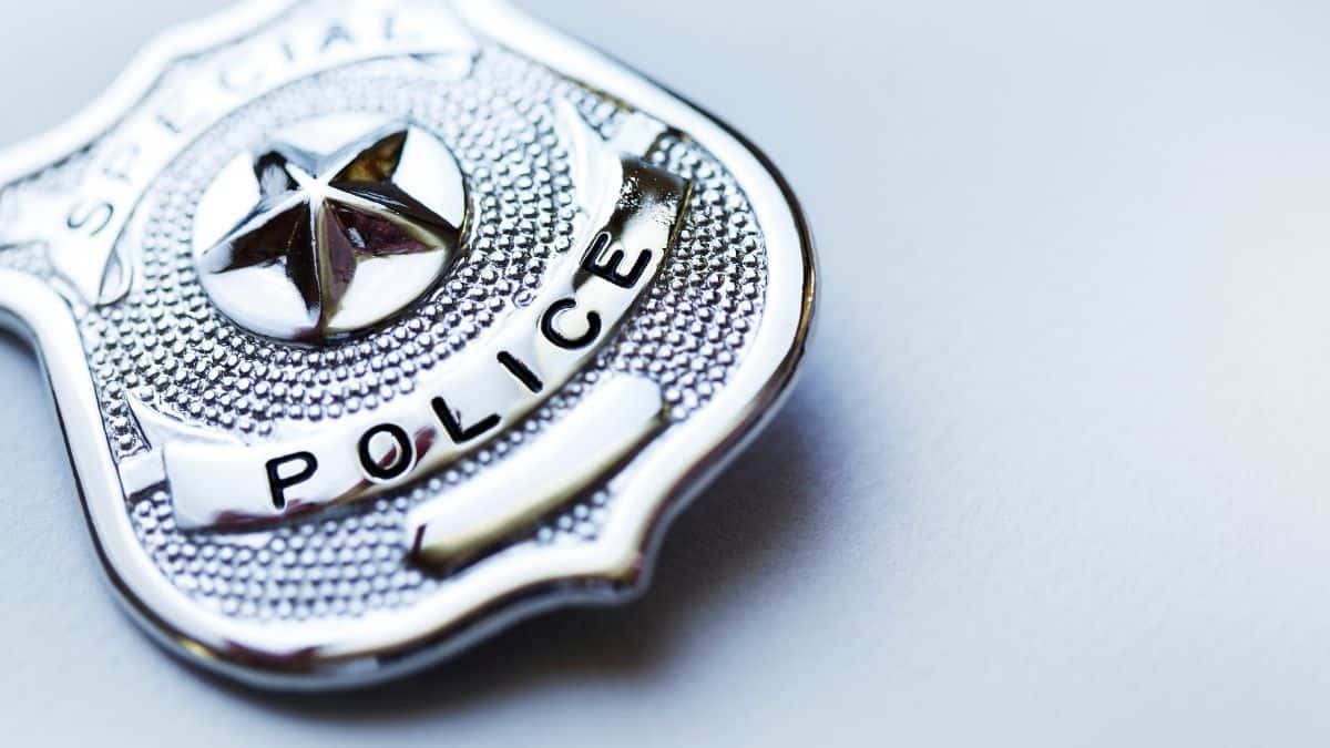 A police badge sitting on a grey table, breaking food rules and challenging the food police, examples of intuitive eating.