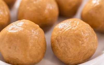 Close up of peanut butter bals on a white plate.
