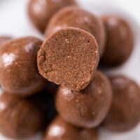 close image of chocolate bliss balls with protein on white plate