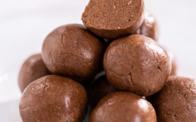 text with chocolate protein balls on white plate